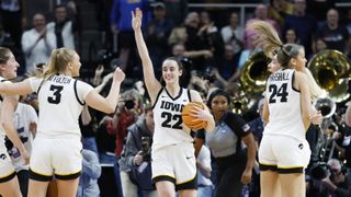 Caitlin Clark #22 of the Iowa Hawkeyes and her teammates celebrate after beating the LSU Tigers 94-87 for a place in the Final Four 2024 at March Madness