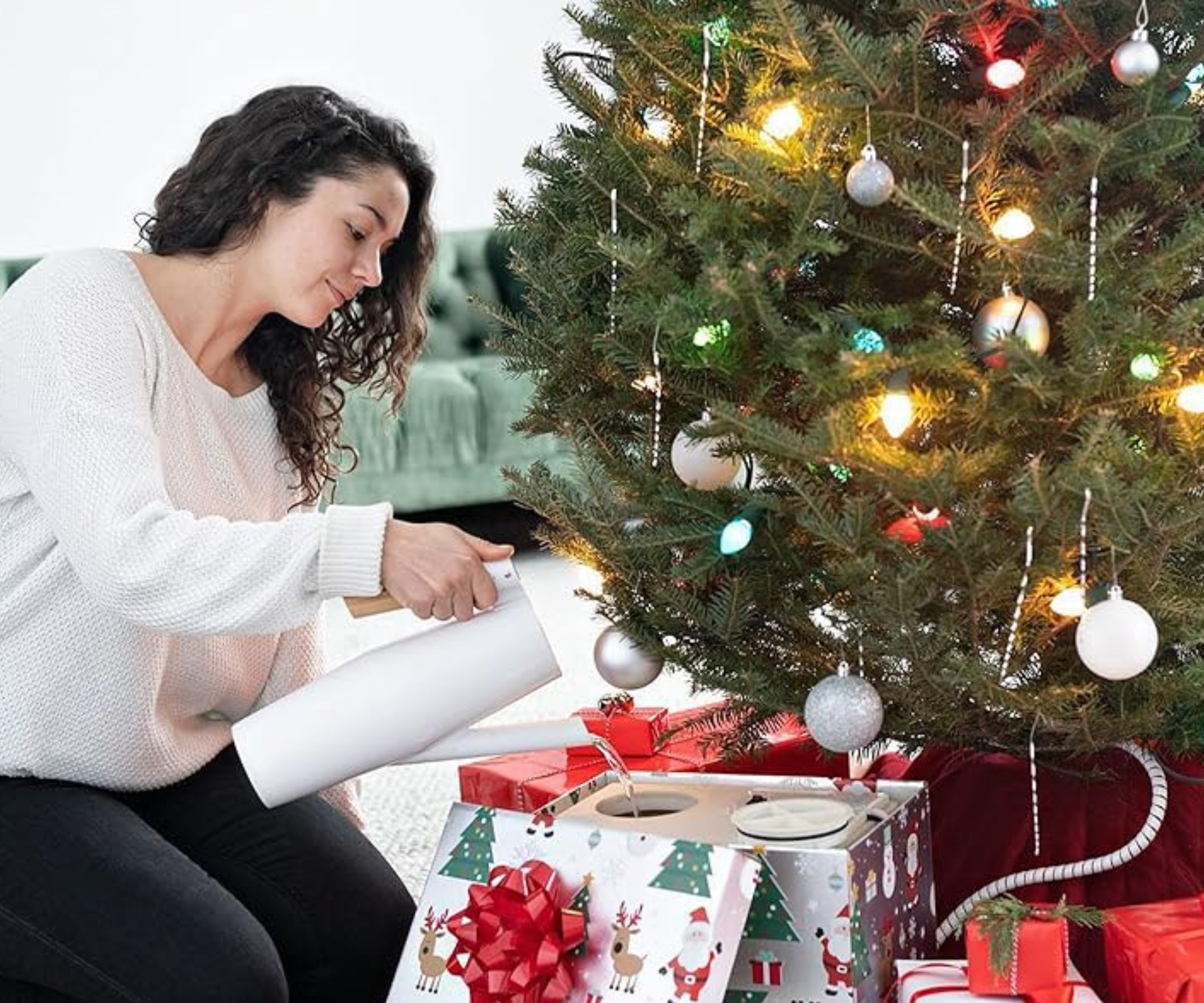 HoHoHoH2o Christmas tree watering system in use under decorated tree