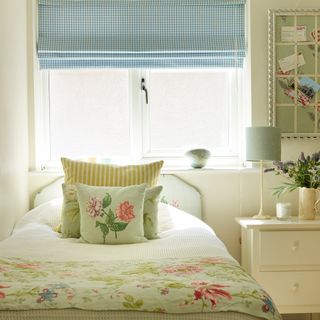 Cream bedroom with blue gingham blinds and floral bedlinens