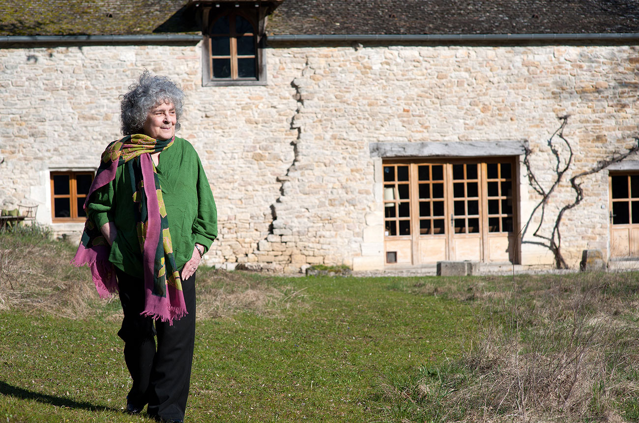 Becky Wasserman-Hone in front of farmhouse