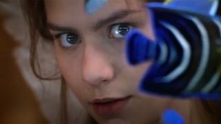 Claire Danes looks at Leonardo DiCaprio from one side of a glass fish tank.