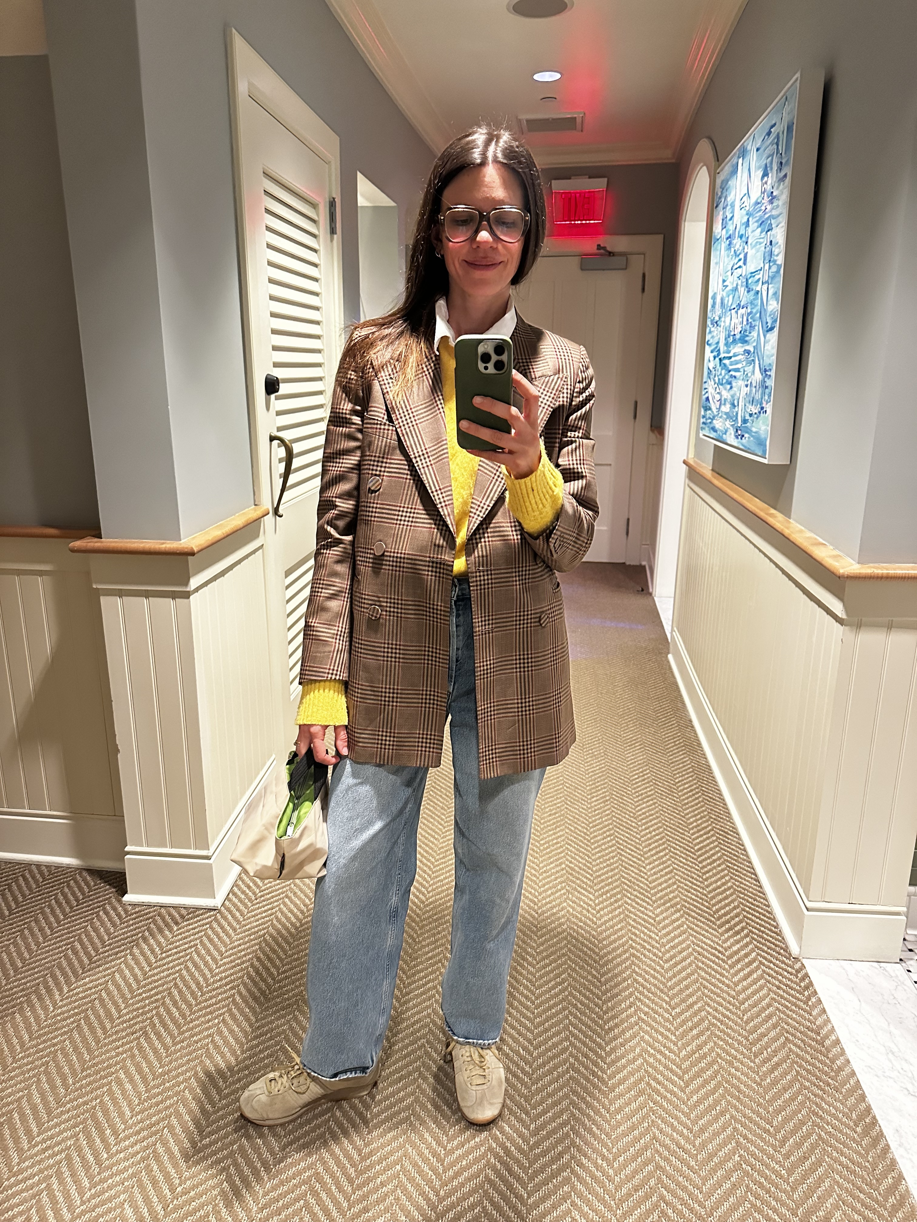 Mirror selfie of Julia Gall with her green Herv&amp;eacute; Chapelier bag, styled with an oversized houndstooth blazer and light wash jeans