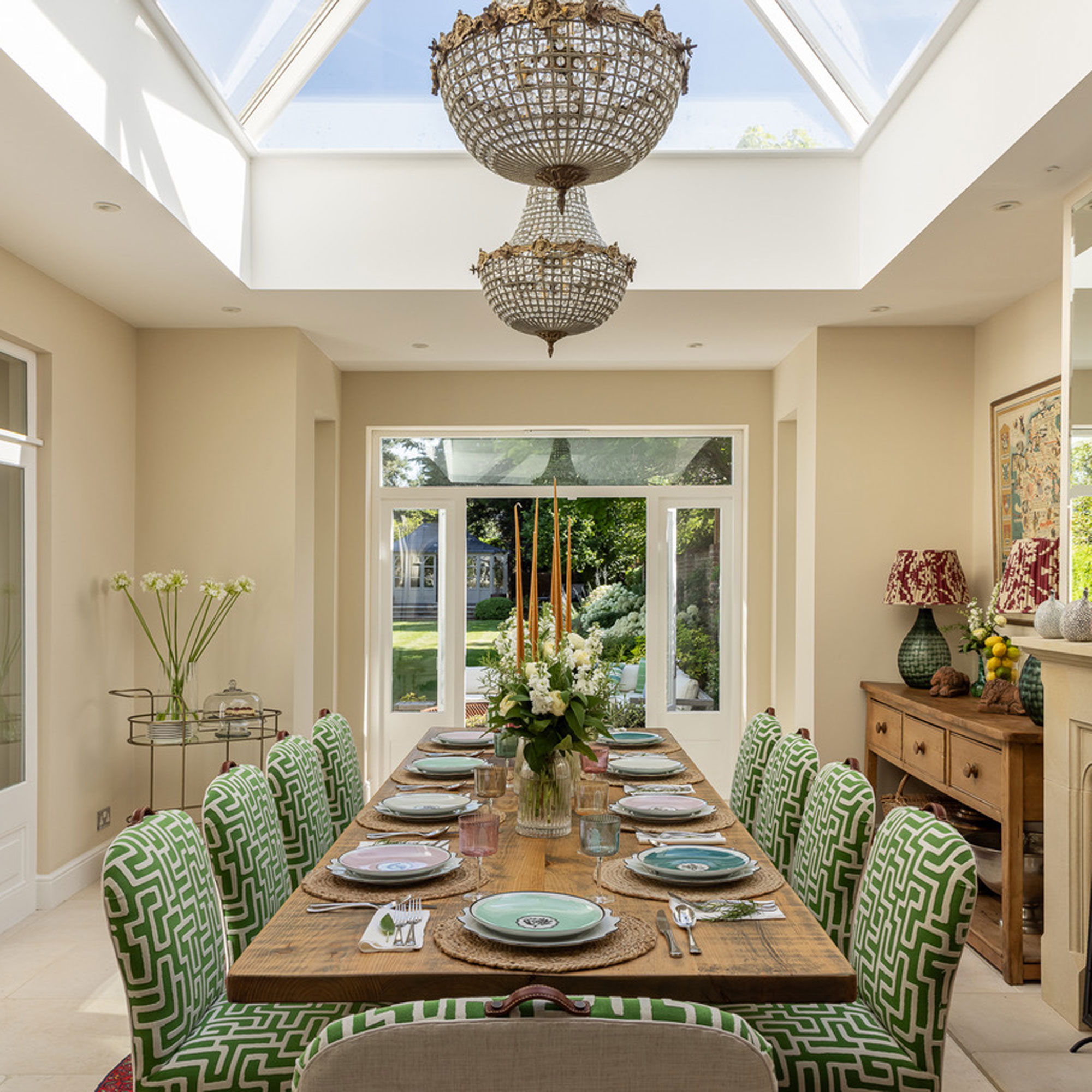 orangery dining room with green geometric dining chairs