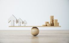 Metallic Arrows and Gold Coin Stack On Wooden Seesaw symbolising value investing versus momentum investing