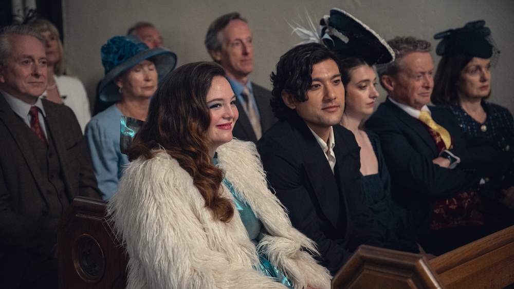 Jess from too much wears a turquoise dress and a fur coat to a wedding