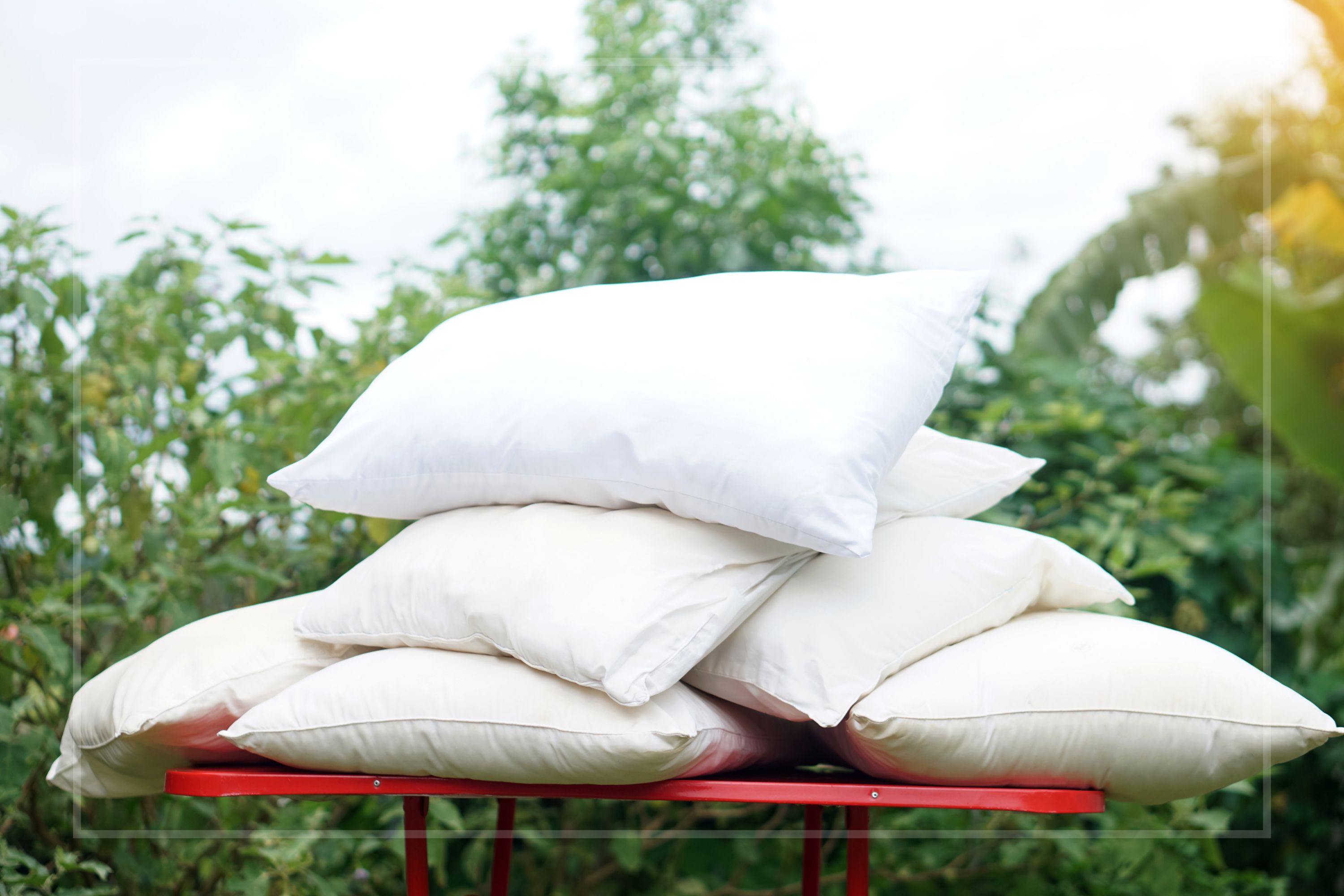 Pillows piled up drying in the garden 