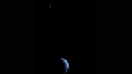 This picture of a crescent-shaped Earth and Moon, the first of its kind ever taken by a spacecraft, was recorded Sept. 18, 1977, by NASA's Voyager 1 when it was 7.25 million miles (11.66 million kilometers) from Earth. Credit: NASA/JPL