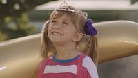 Michelle Tanner (Mary-Kate or Ashley Olsen) smiles at Walt Disney World on Full House.