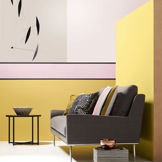 room with sofa and yellow wall