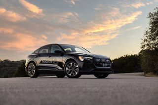 Audi with holoride branding in front of sunset