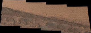 A wheel track deliberately cuts through a windblown ripple of dusty sand in this composite image taken by NASA's Curiosity Mars rover on Nov. 7, 2014.