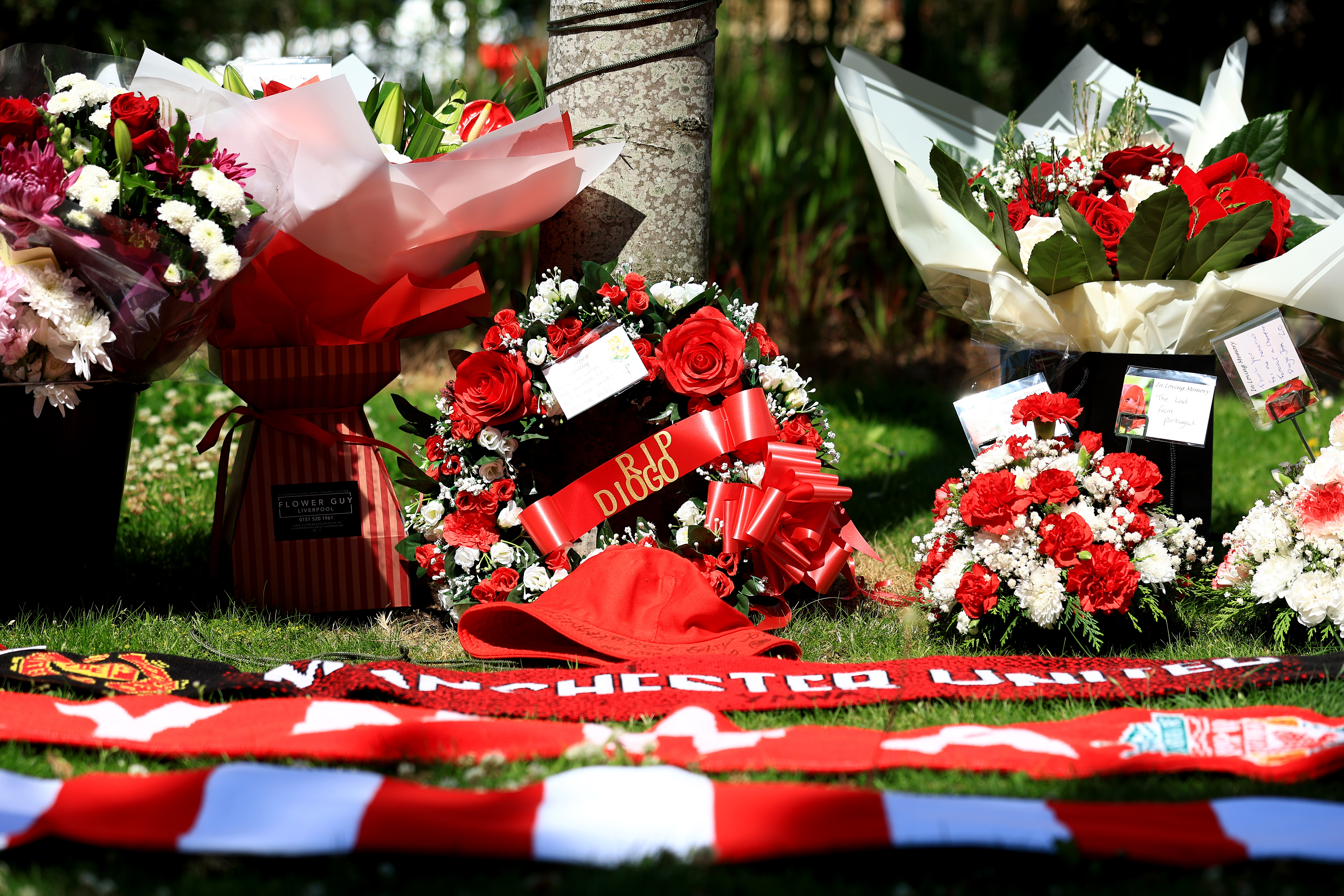 Floral tributes and scarves left at Anfield in memory of Diogo Jota