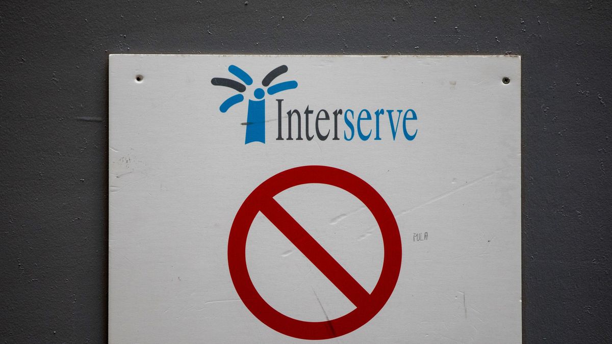 Interserve logo on a sign at a construction site with a red &amp;#039;no entry&amp;#039; symbol beneath it