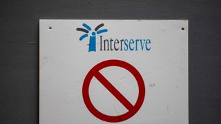 Interserve logo on a sign at a construction site with a red 'no entry' symbol beneath it
