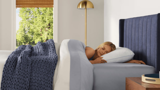 Woman sleeping on a Tempur-Pedic white pillow in a brightly lit room