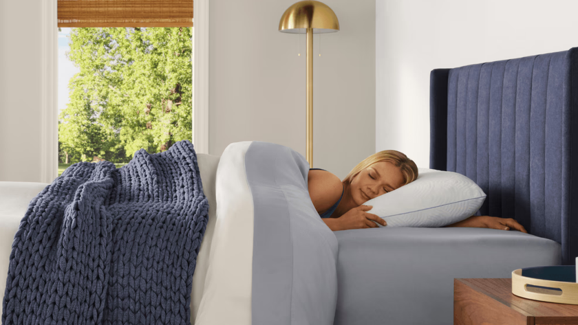 Woman sleeping on a Tempur-Pedic white pillow in a brightly lit room