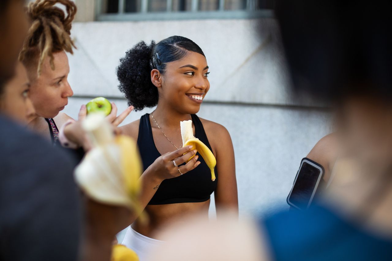 A woman eating a banana for breakfast