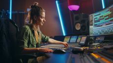 a woman using a music mixing desk