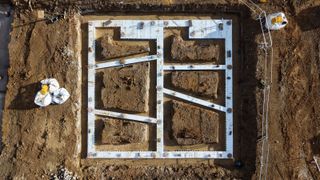 bird's eye view of detached house foundations dug into the soil