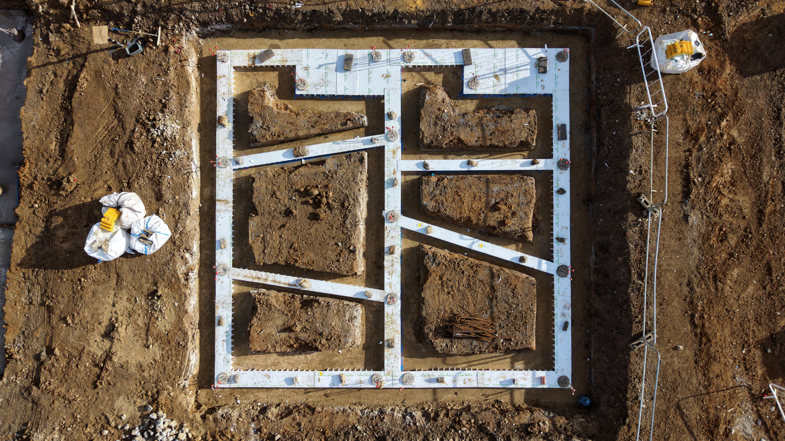 bird's eye view of detached house foundations dug into the soil