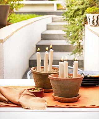 garden with steps and decorated by candle light in terracotta pots