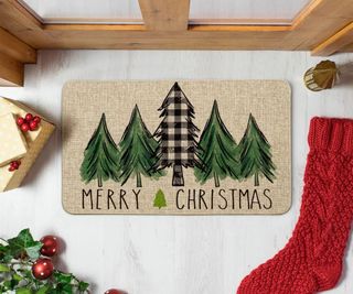 Christmas doormat with a red stocking beside it