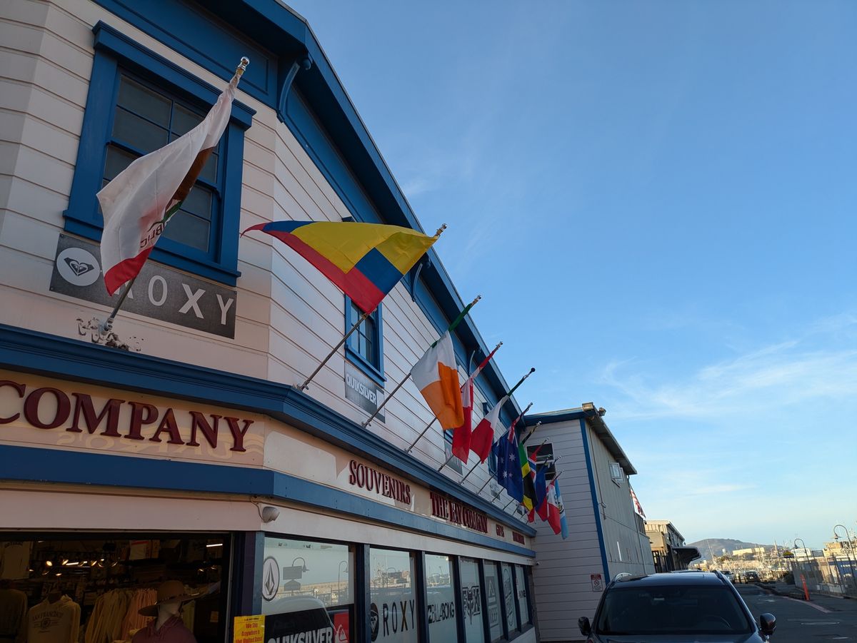 Flags flying outside a souvenir shop shot by the Pixel 8a