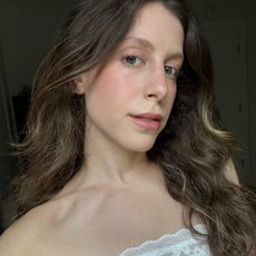 Jamie Schneider taking a selfie wearing a white dress