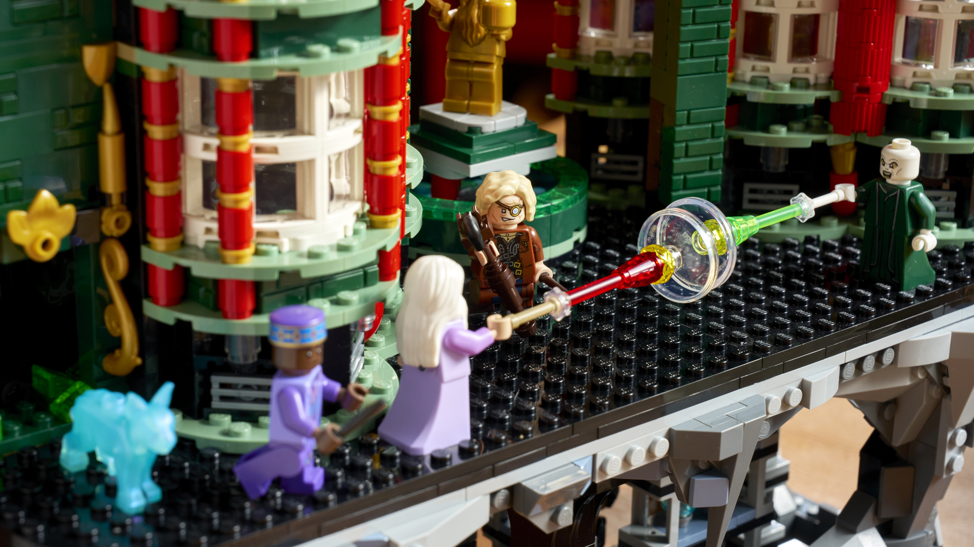 Lego Dumbledore and Voldemort fire spells at each other in the Lego Ministry of Magic Atrium