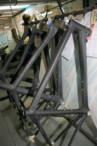 Carbon bikes awaiting coating. Note the transfers for each to the right of the picture
