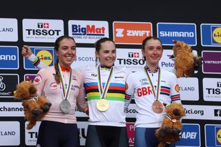 Silver medalist Shirin Van Anrooij, gold medalist Blanka Vas Kata, and bronze medalist Anna Shackley celebrate on the podium during the U23 women's medal ceremony after the combined U23-elite women's road race at the World Championships in Glasgow 2023