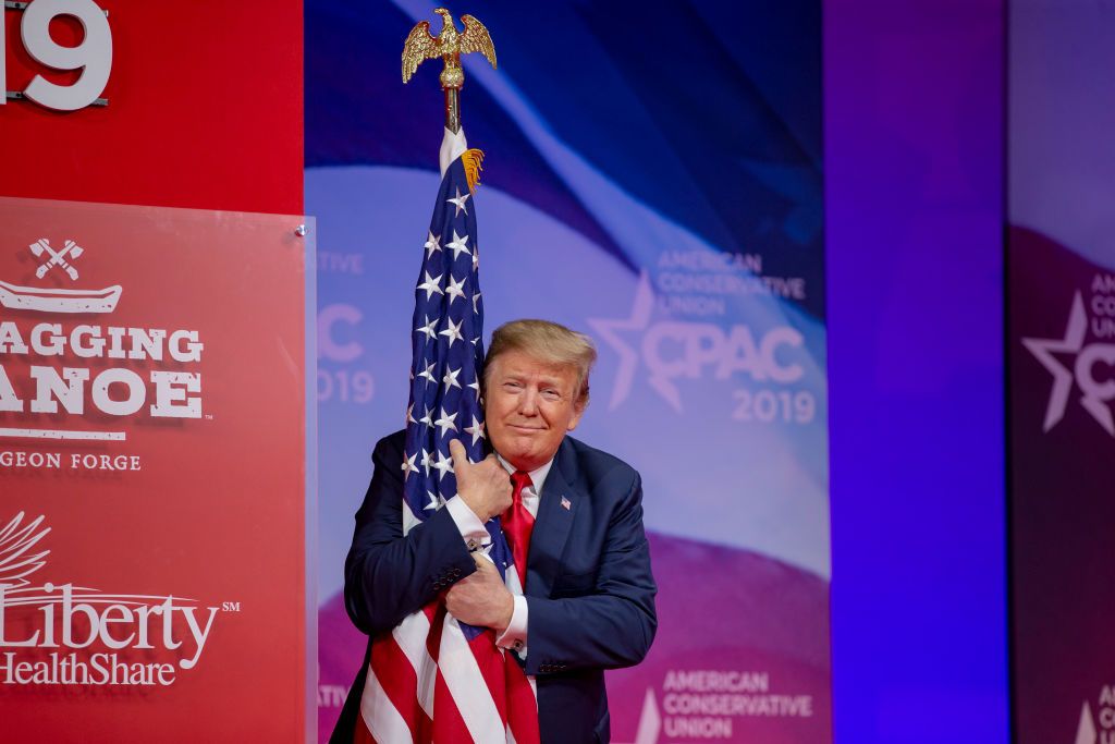 Trump hugs the flag