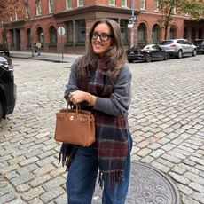 Emma Leger in a grey sweater and plaid scarf