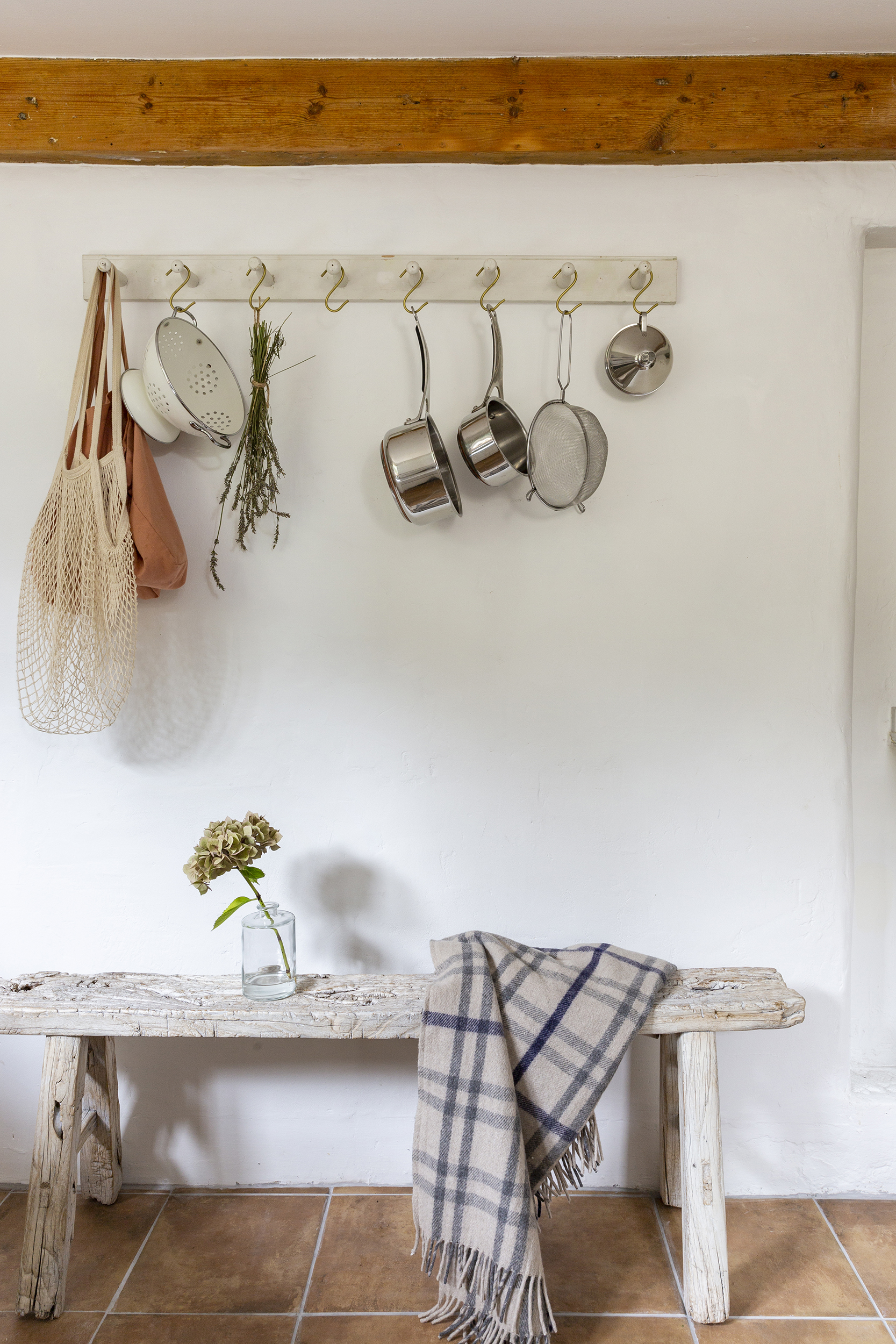 Pots and pans hanging from pegs in Victorian cottage