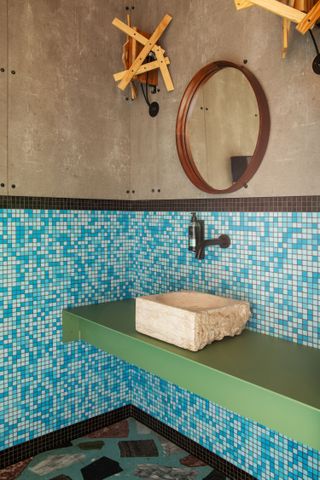 A concrete block serves as the bathroom sink