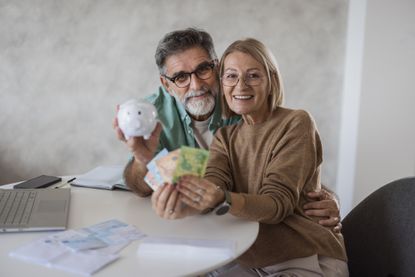 a picture of a happy couple saving money