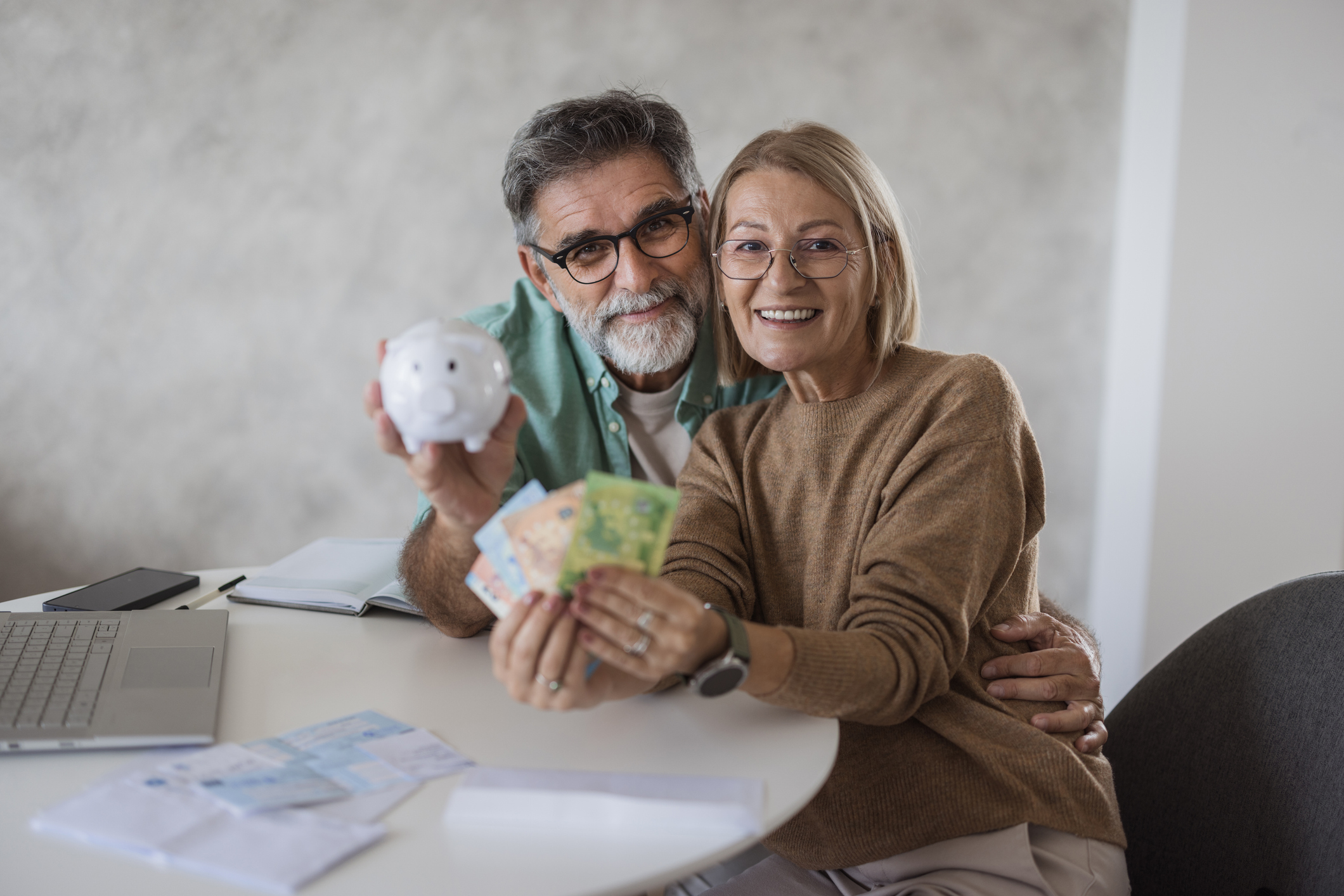 a picture of a happy couple saving money