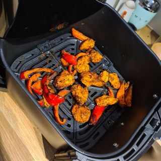 Proscenic T22 Air Fryer basket with cooked chicken and red peppers
