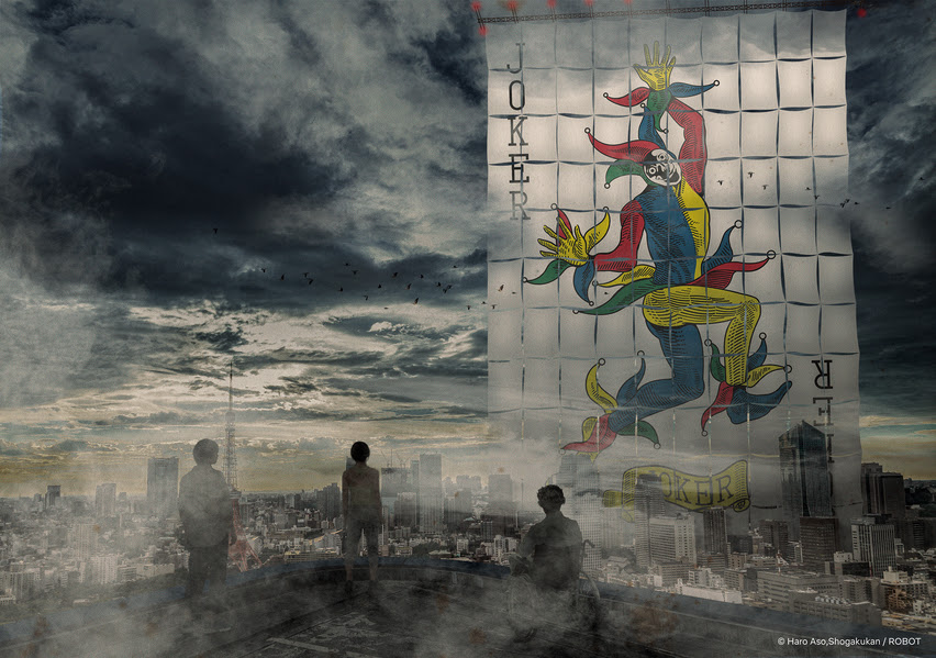 Three people standing on a roof look at a giant poster of a Joker card, in a promo still for 'Alice in Borderland' season 3.