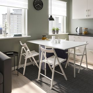 kitchen room with kitchen cabinets and white table with chairs