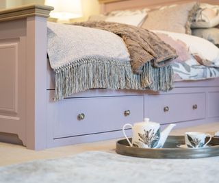 pink wooden bed with storage drawers