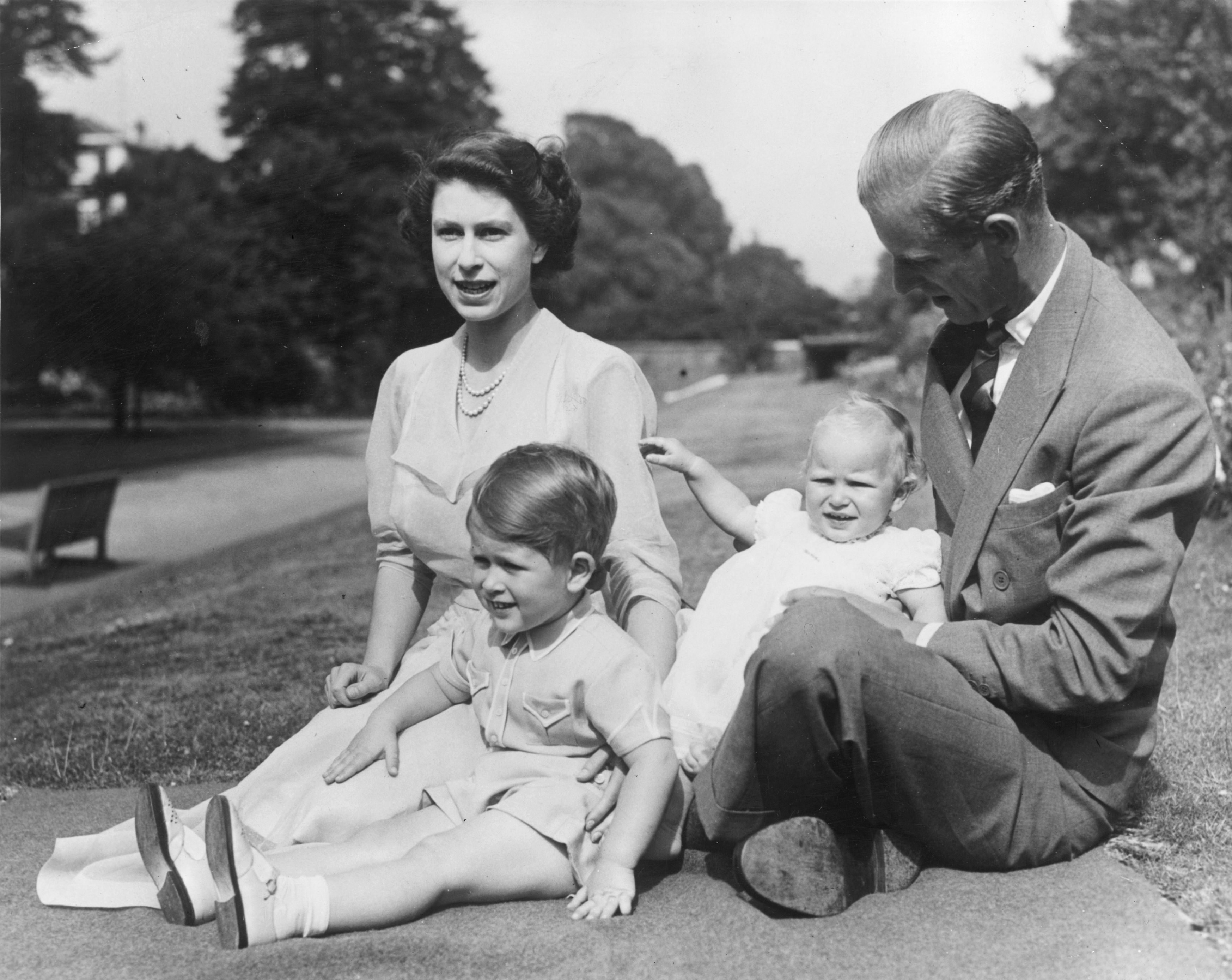9th August 1951: Princess Elizabeth and Prince Philip, Duke of Edinburgh with their two children, Prince Charles and Princess Anne in the grounds of Clarence House, London. (Photo by Fox Photos/Getty Images)