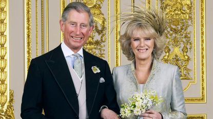 King Charles and Queen Camilla’s wedding date was rescheduled. Seen here the couple pose for their official photograph in the White Drawing Room