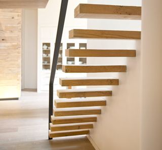 A delicate staircase leads up to the mezzanine level