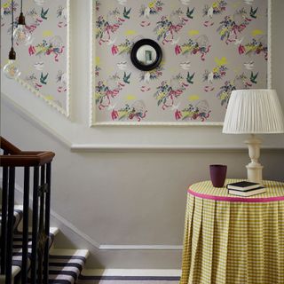 Grey stair case with panels of wallpaper