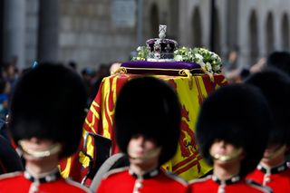 The Imperial State Crown is seen on the coffin carrying Queen Elizabeth II during the procession for the Lying-in State of Queen Elizabeth II on September 14, 2022 in London, England. Queen Elizabeth II's coffin is taken in procession on a Gun Carriage of The King's Troop Royal Horse Artillery from Buckingham Palace to Westminster Hall where she will lay in state until the early morning of her funeral.