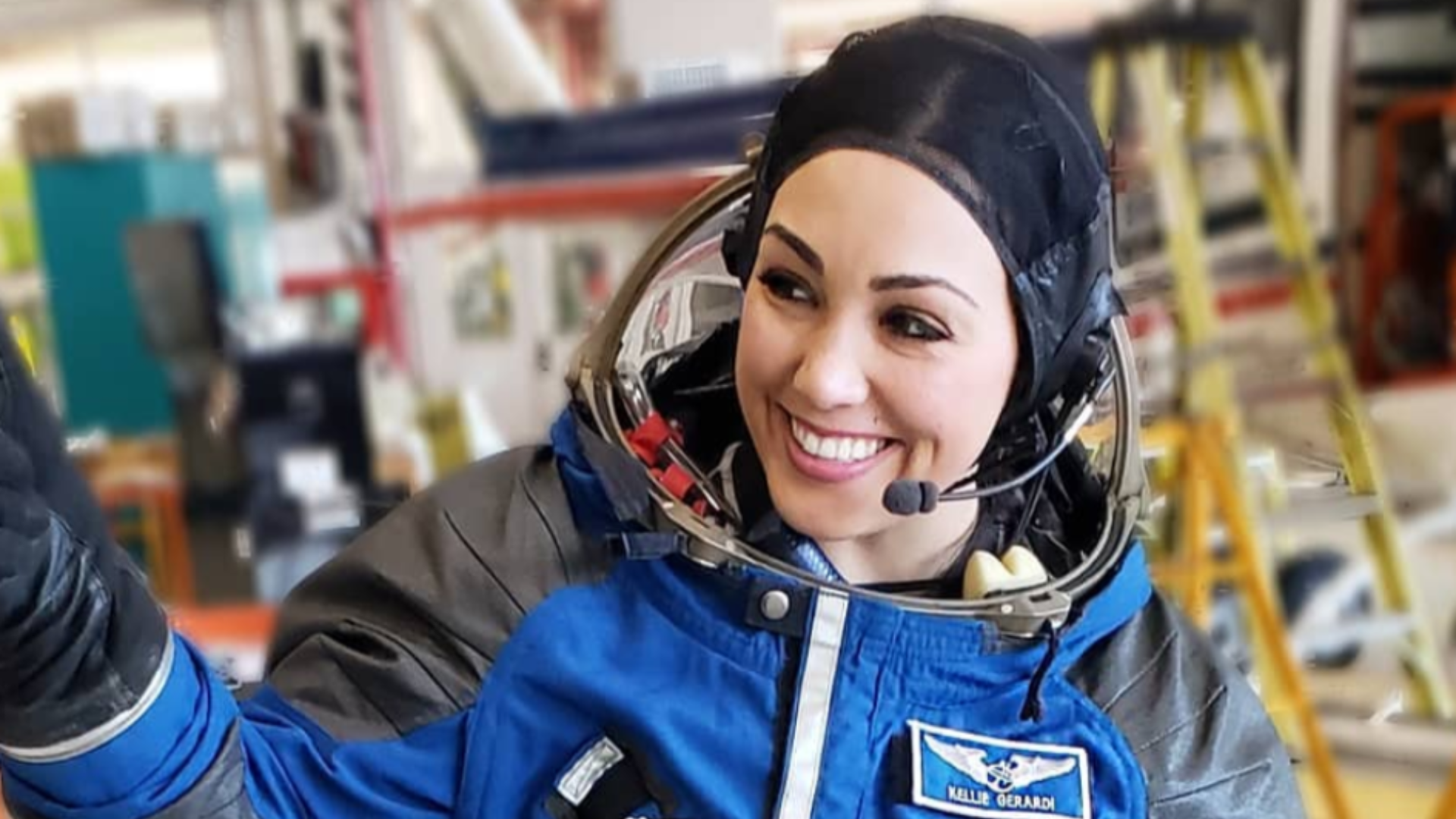Kellie Gerardi in a blue flight suit. 