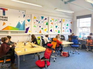 Co-working space with rainbow-coloured decorations on wall