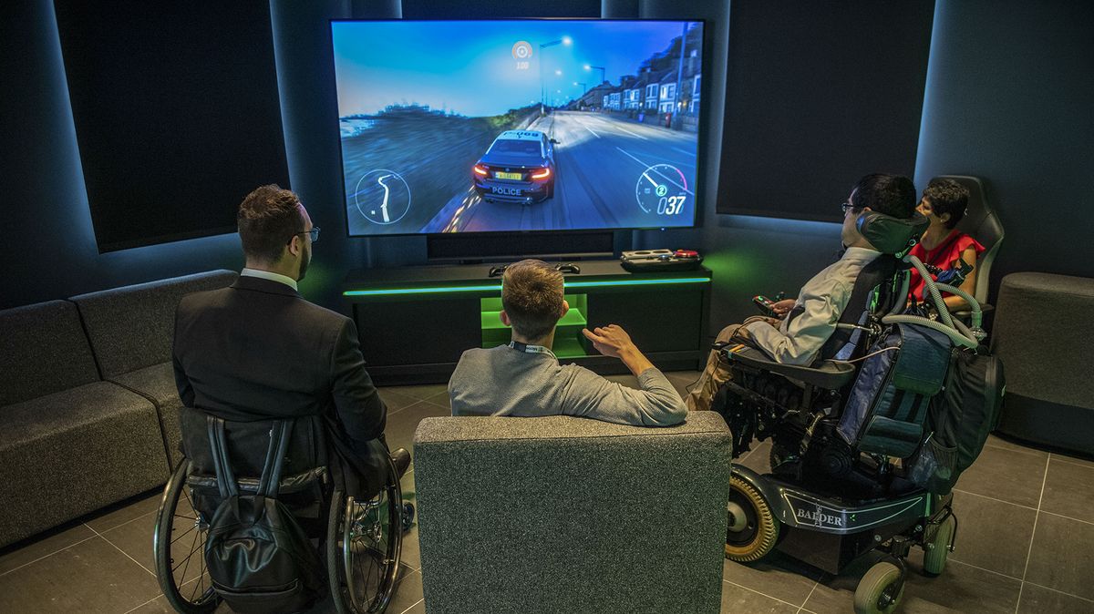 Attendees to an early access event play on an Xbox console racing game at the new Microsoft Corp. flagship store in central in London, U.K., on Tuesday, July 9, 2019.