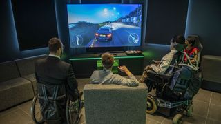 Attendees to an early access event play on an Xbox console racing game at the new Microsoft Corp. flagship store in central in London, U.K., on Tuesday, July 9, 2019.